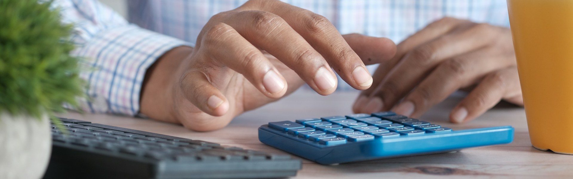 Hands working a calculator, like the business valuation assumptions and judgment calls behind a divorce appraisal