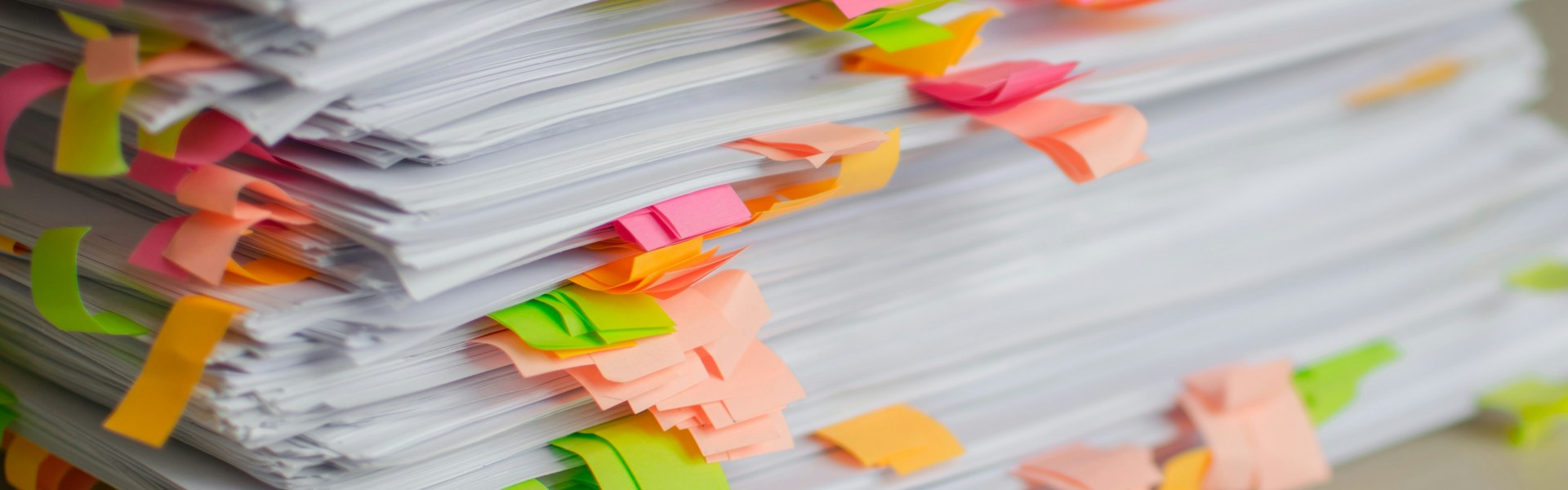 Business valuation report pages flagged with sticky tabs, ready to read and question in a divorce case