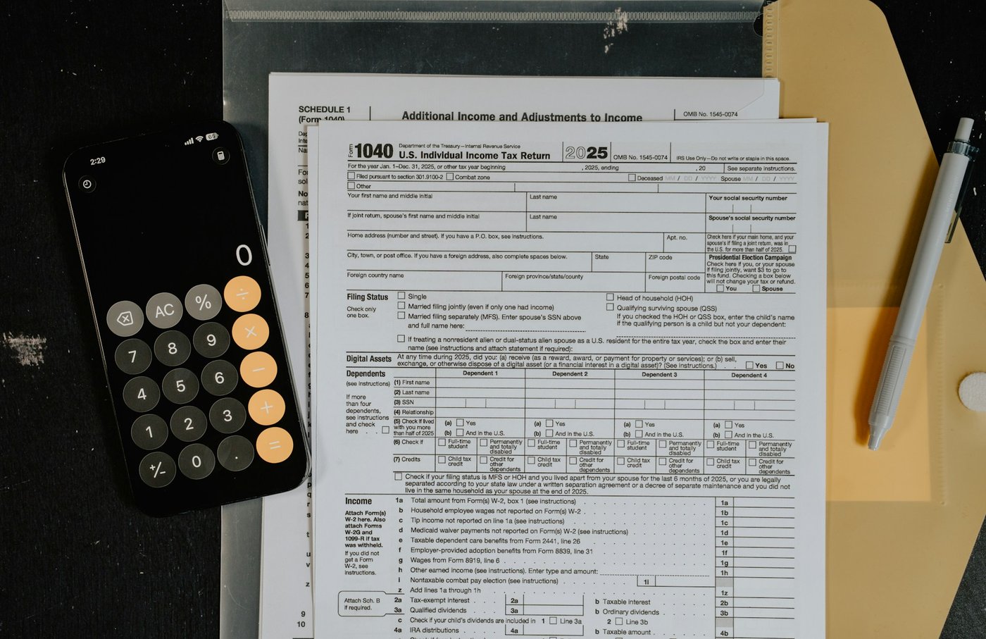 Tax forms and calculator used to determine a business owner’s income for child support