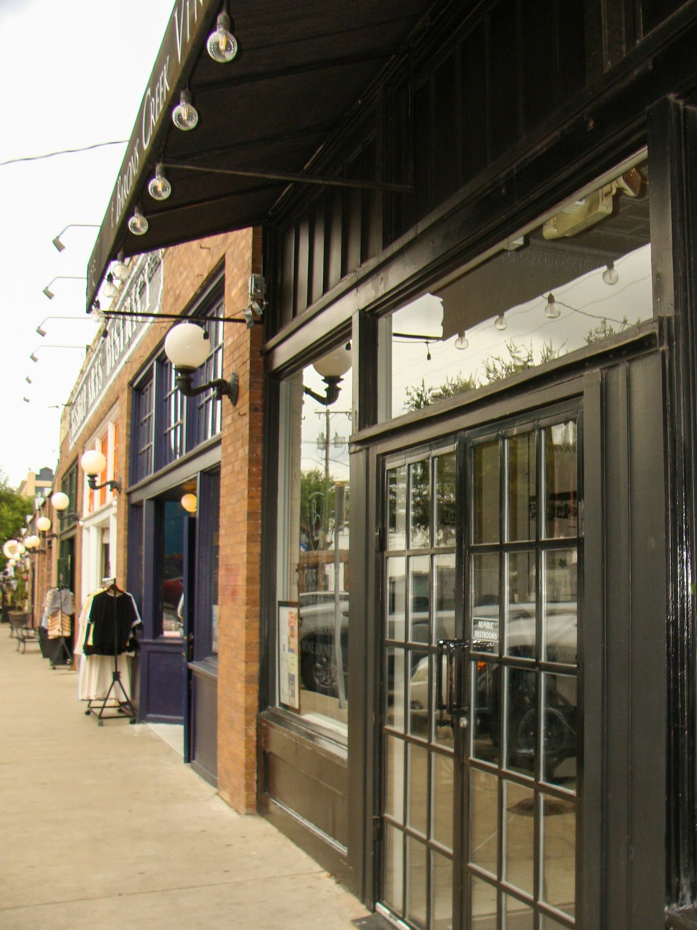 Small business storefronts on a lit sidewalk, the kind of family business divided in a Washington divorce