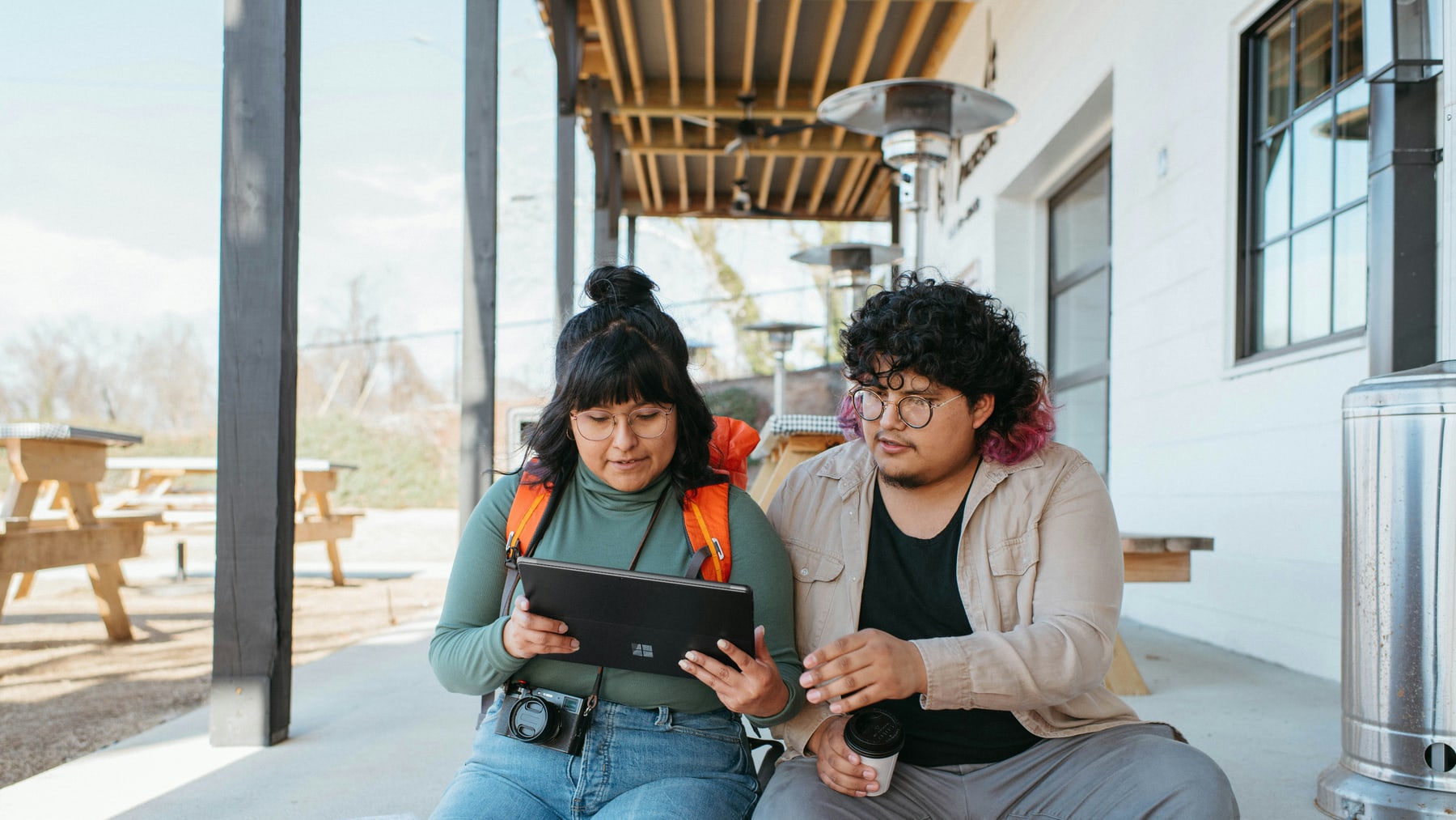 Two adults reviewing a tablet, used for an article about a Tulalip Tribal Court parenting plan.
