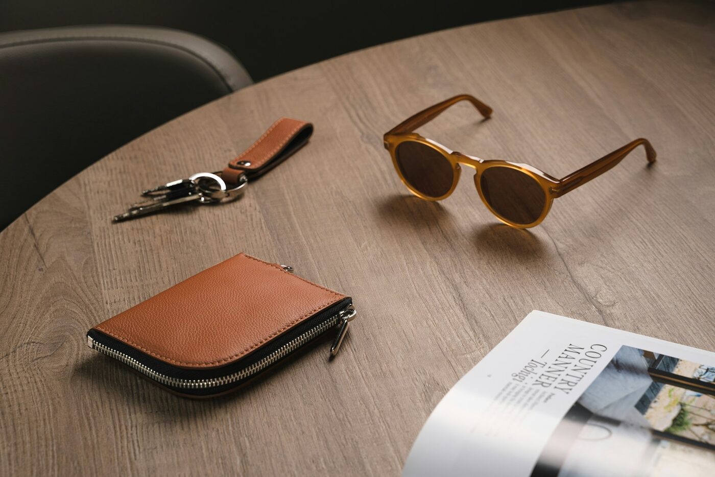 A leather wallet, keys, and sunglasses on a wooden table, paying your own attorney fees when a committed intimate relationship ends in Washington