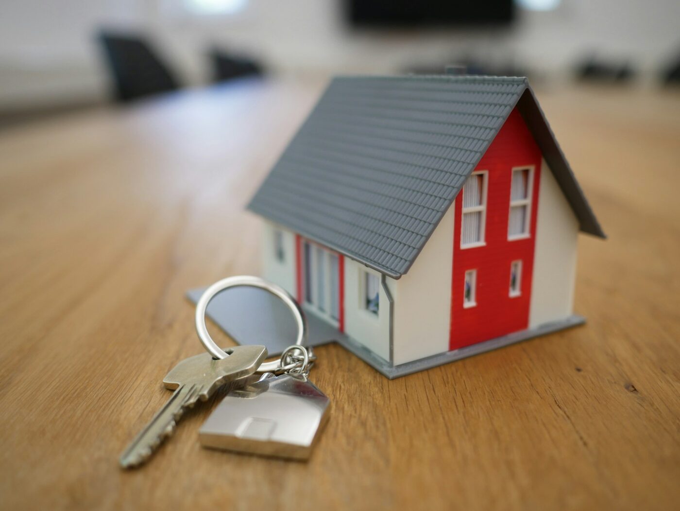 A small model house and a set of keys on a wooden table, what a committed intimate relationship means for unmarried couples who built a home together in Washington