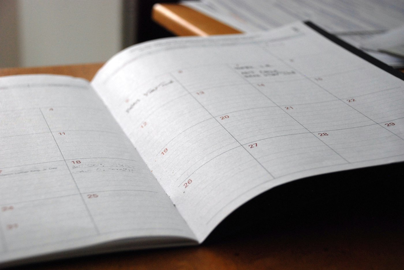 Open monthly planner on a wooden desk, illustrating how long a divorce takes in Snohomish County