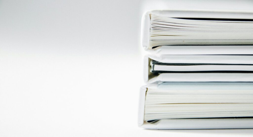 Stack of thick white binders on a white surface, the declarations for a temporary orders hearing in Snohomish County