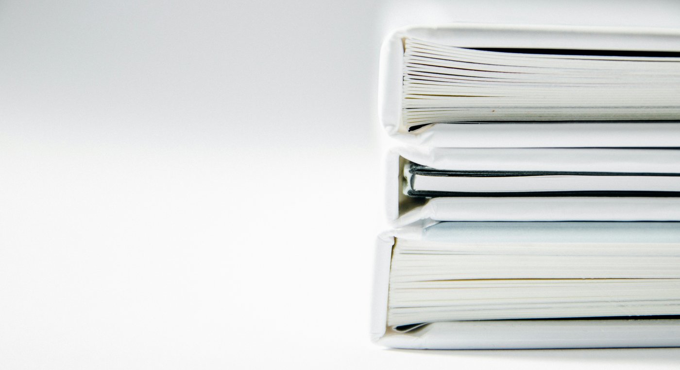 Stack of thick white binders on a white surface, the declarations for a temporary orders hearing in Snohomish County